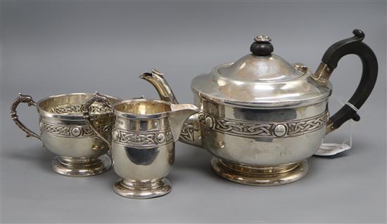 A George V Arts & Crafts silver three piece tea set, A.E Poston & Co Ltd, Birmingham, 1935, gross 31.5 oz.